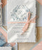 Announce your wedding with elegance and artistry through our handmade paper Save the Date cards, adorned with a soft blue watercolor floral wreath and tied with a delicate blush silk ribbon. Each card is crafted on luxury 100% cotton handmade paper with naturally torn deckled edges, creating a timeless and romantic keepsake that beautifully reflects your love story.