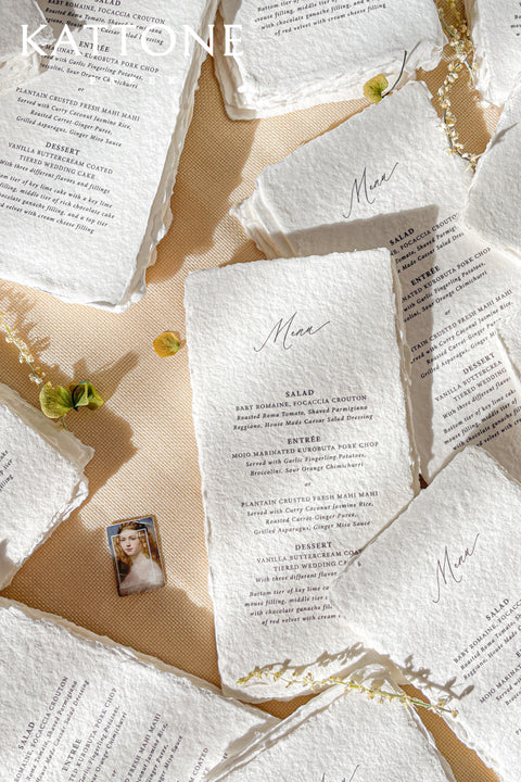 Elevate your tablescape with our handmade paper wedding menus, meticulously crafted from luxury cotton paper with naturally torn deckled edges. Each piece exudes timeless refinement - perfect for romantic, fine-art, or destination weddings. Featuring minimalist typography and soft organic texture, these menus create a cohesive, elegant setting that beautifully complements your stationery suite and enhances your guests’ dining experience.