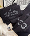 Black wedding envelopes with white ink address printing and hand-drawn venue liners styled with fine art stationery and neutral flat lay details.