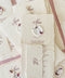 Handmade paper wedding menu with deckled edges, wax seal detail, personalized name tag, fine art reception stationery flat lay.