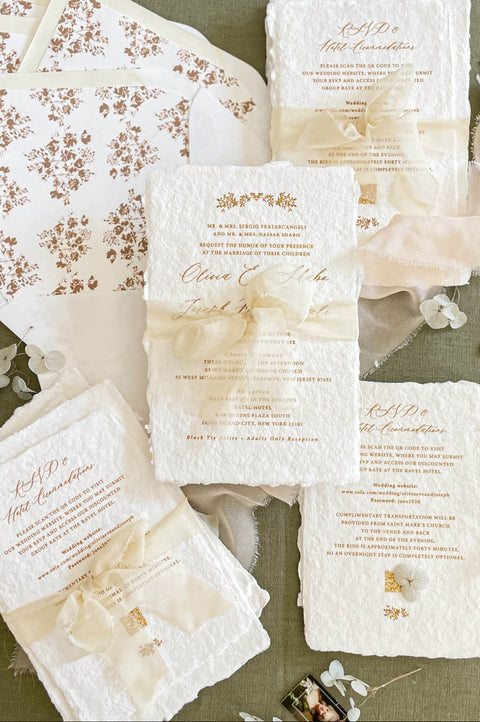 Handmade cotton paper wedding invitation suite with deckled edges, sepia floral design, sheer ivory silk ribbon and coordinated botanical envelope liners.