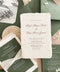 Luxury handmade paper wedding invitation suite featuring deckled edge cotton paper, deep green envelopes, elegant calligraphy typography, and custom venue illustration for sophisticated wedding stationery.