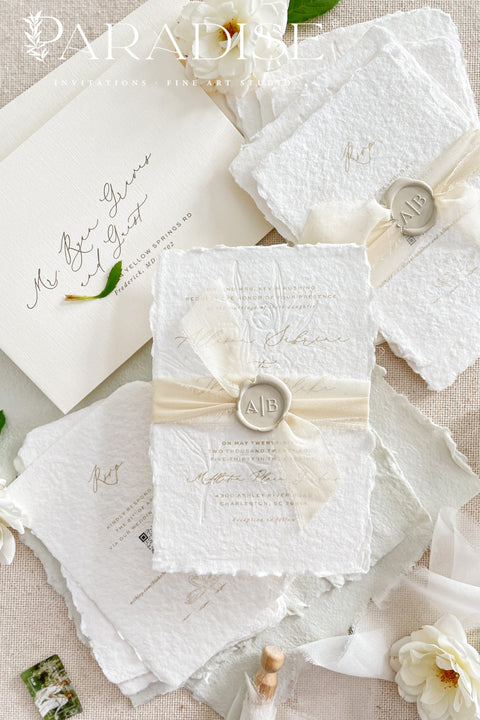 This exquisite wedding invites suite offers a blend of natural elegance and modern sophistication. Printed on luxurious handmade cotton paper in a soft ivory hue, each invitation features a delicate blind embossed floral design. A touch of refined artistry is added with elegant modern calligraphy, creating a truly classy wedding stationery set that beautifully hints at your special day.