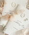 Luxury handmade paper wedding vows booklet featuring deckled edge cotton paper, elegant typography, chiffon ribbon ties, and wax seal accents.