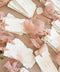 Handmade wedding place cards with deckled edges, soft blush silk ribbon and elegant script names on cotton paper.