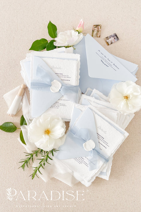 Delicate, refined, and beautifully personal - our handmade wedding invitations with a monogram crest are designed to capture the essence of timeless romance. Printed on luxury cotton paper with soft deckled edges, made entirely by hand and tied with a light blue silk ribbon for a graceful finishing touch. The custom monogram crest adds an elegant and personal element, making every suite unique to you and your story.