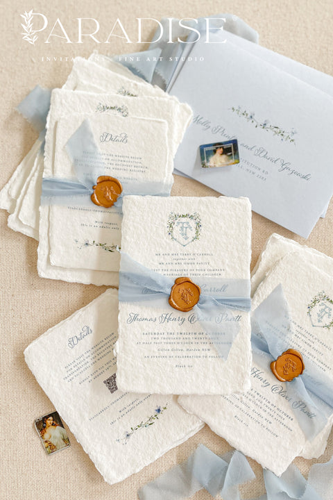 This exquisite wedding invitations suite offers a blend of vintage romance and personalized artistry. Each handmade paper invitation is a work of fine art, featuring a beautifully hand-painted custom watercolor monogram in a vintage letter style. The serene blue tones create a truly timeless and elegant feel, making these beautiful and heartfelt invites a perfect preview of your special day.