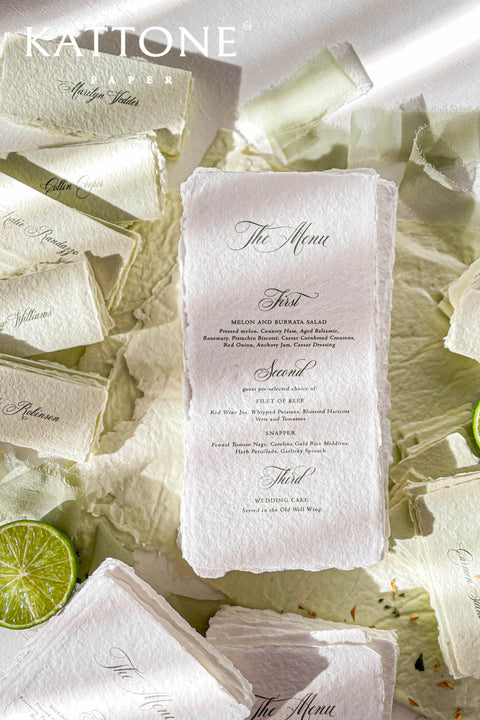 These handmade paper wedding menus are a true expression of understated luxury and timeless romance. Meticulously crafted from 100% cotton rag paper, each menu features naturally deckled edges that reflect the artistry of traditional papermaking. The soft, tactile texture pairs beautifully with classic calligraphy-inspired typography, evoking an old-world charm that feels both intimate and refined.