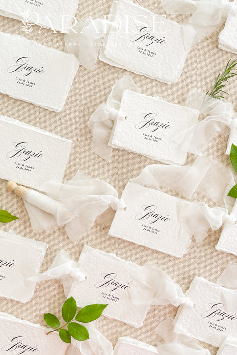 Add refined romance to your event with our handmade paper place cards, crafted from luxurious cotton rag paper and finished with softly torn deckled edges. Each card features elegant calligraphy and a hand-tied chiffon ribbon, creating a dreamy fine-art aesthetic perfect for weddings, bridal showers, rehearsal dinners, and upscale celebrations. Designed to elevate your tablescape, these artisan place cards bring texture, movement, and timeless charm to every setting.