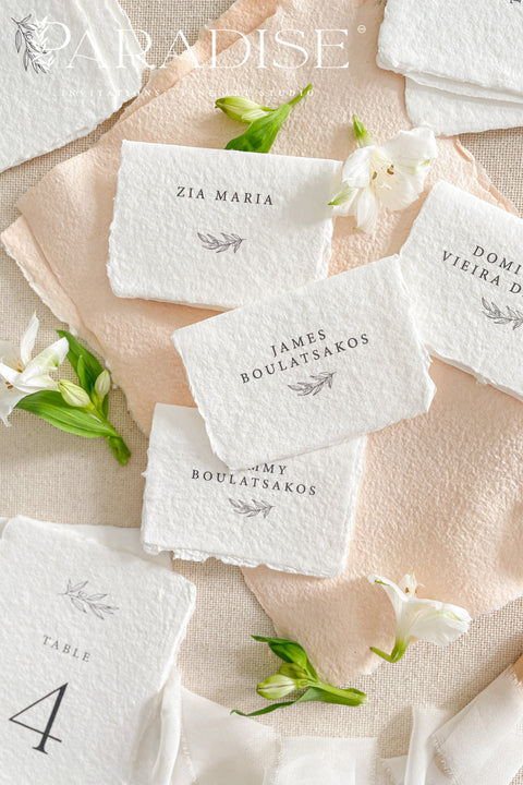 Elevate your event with our handmade paper place cards, crafted from luxurious cotton rag paper and finished with naturally torn deckled edges. Each card features minimalist typography paired with a delicate botanical illustration, creating a refined fine-art look perfect for weddings, rehearsal dinners, and intimate celebrations. These artisan-crafted place cards bring organic texture, timeless elegance, and a soft romantic touch to any tablescape.