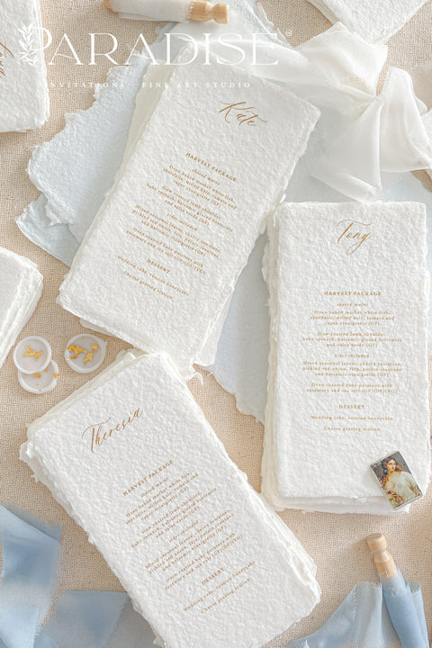 These handmade paper wedding menus embody effortless sophistication and artisanal beauty. Each piece is crafted from luxurious 100% cotton rag paper, featuring naturally deckled edges and a tactile texture that evokes fine art elegance. The menus are adorned with gold calligraphy-style text, creating a graceful contrast against the soft white handmade paper - a perfect fusion of classic romance and modern refinement.