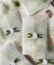 Vellum jackets and white wax seals with velvet ribbons