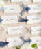 Add soft, romantic detailing to your tablescape with our silk ribbon handmade paper place cards, crafted from premium cotton rag paper and finished with naturally torn deckled edges. Each name tag is threaded with airy, hand-dyed silk ribbon and printed in elegant calligraphy, creating a luxurious fine-art look for weddings, rehearsal dinners, and intimate celebrations. These artisan-crafted cards bring movement, texture, and timeless beauty to your event design.