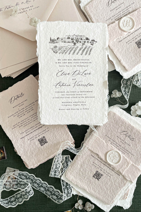 Luxury handmade cotton paper wedding invitation with deckled edges and venue illustration, styled with blush inserts, lace ribbon, wax seals and neutral envelopes on deep green background.