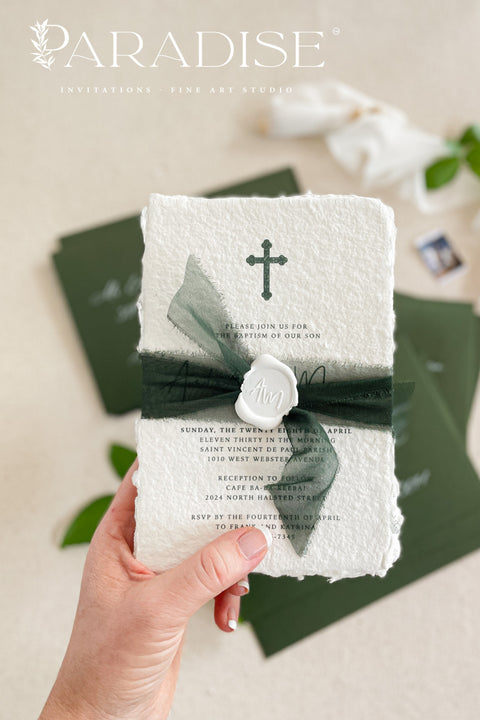 A timeless christening invitation crafted from luxurious handmade paper and finished with deep green silk ribbon and a wax seal accent. Featuring a delicate Christian cross and refined typography, this design honors faith and tradition with understated elegance. Perfect for baptisms and church ceremonies, it offers a meaningful keepsake that reflects the sacred beauty of the occasion.