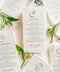 These embossed handmade paper wedding menus embody the essence of refined elegance and timeless artistry. Each piece is crafted from 100% cotton rag paper, known for its organic texture and signature deckled edges that add an artisanal, heirloom feel. The design features delicate blind embossing of botanical motifs, adding soft dimension and sophistication, while luxurious typography in classic ink beautifully contrasts the natural paper’s tactile surface.