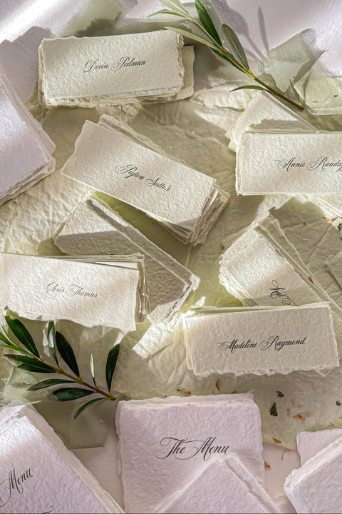 Bring artisanal beauty to your event with our handmade paper place cards, crafted from luxurious cotton rag paper and detailed with natural deckled edges. Each card features a pressed dried floral element sealed beneath a creamy wax stamp, creating a textured fine-art look perfect for garden weddings, outdoor celebrations, and romantic gatherings. These one-of-a-kind place cards add organic charm, timeless artistry, and meaningful detail to every tablescape.