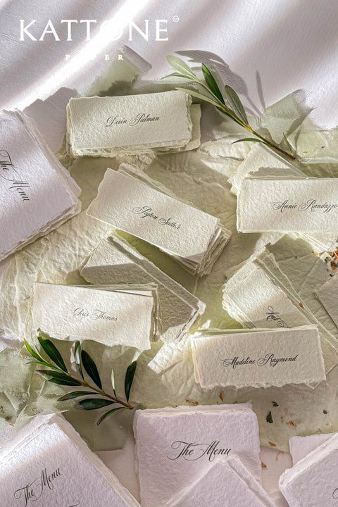 Bring artisanal beauty to your event with our handmade paper place cards, crafted from luxurious cotton rag paper and detailed with natural deckled edges. Each card features a pressed dried floral element sealed beneath a creamy wax stamp, creating a textured fine-art look perfect for garden weddings, outdoor celebrations, and romantic gatherings. These one-of-a-kind place cards add organic charm, timeless artistry, and meaningful detail to every tablescape.