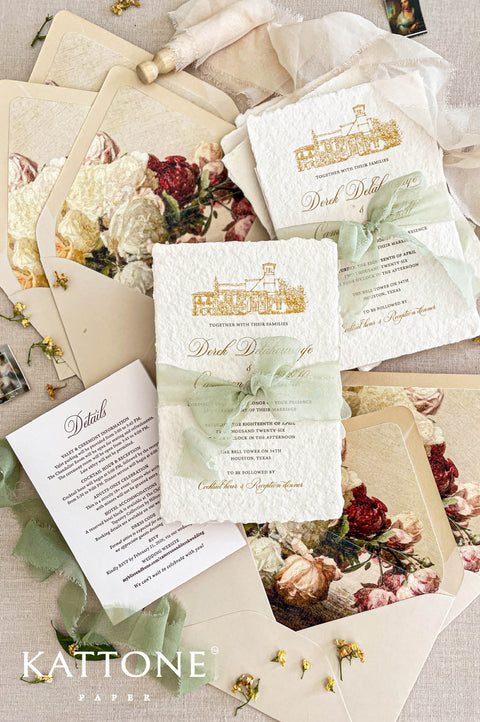 Luxury handmade cotton paper wedding invitation with deckled edges and gold venue illustration, styled with sage silk ribbon, floral envelope liners and coordinated stationery suite.
