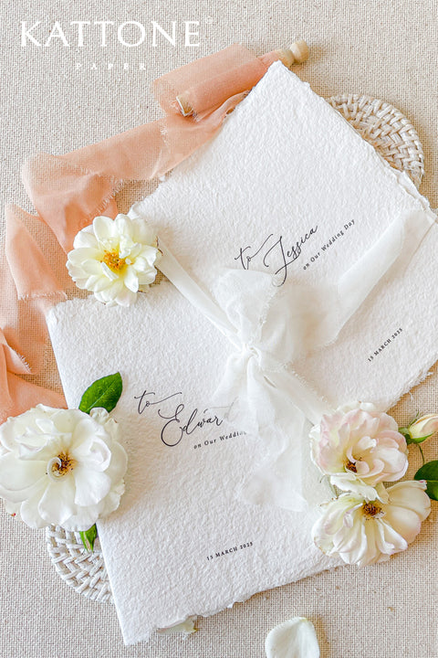 This handmade paper vow renewal invitation captures the beauty of everlasting love and the joy of saying “I do” all over again. Each invitation is printed on luxury deckled-edge cotton paper, cherished for its soft texture and organic edges that speak of authenticity and craftsmanship. The minimalist typography, paired with delicate script, brings a sense of quiet elegance, while the sheer silk ribbon ties everything together - a perfect symbol of two hearts forever intertwined.