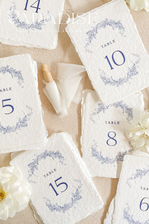 These botanical handmade paper table numbers are crafted on luxurious deckle-edge cotton paper and adorned with elegant blue floral illustrations. Perfect for garden weddings, fine-art celebrations, and romantic décor themes, each card adds refined texture and effortless elegance to your reception tables. Designed to blend natural artistry with timeless style, they create a cohesive and elevated guest experience.