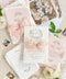 Announce your love story with timeless artistry through our handmade watercolor floral crest wedding invitations, where classic design meets modern elegance. Each invitation is crafted by hand and features a beautifully painted watercolor crest of delicate florals, personalized with your initials - a true symbol of your union.