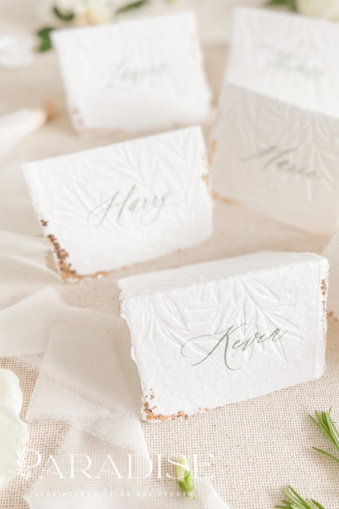 Elevate your table setting with our embossed handmade paper place cards - a luxurious detail for weddings, bridal showers, and upscale events. Each card is crafted from premium cotton rag paper, featuring a soft deckled edge, botanical embossing, and elegant calligraphy. Perfect for seating arrangements, escort cards, or personalized name tags, these artisanal pieces bring a touch of organic elegance to any celebration.