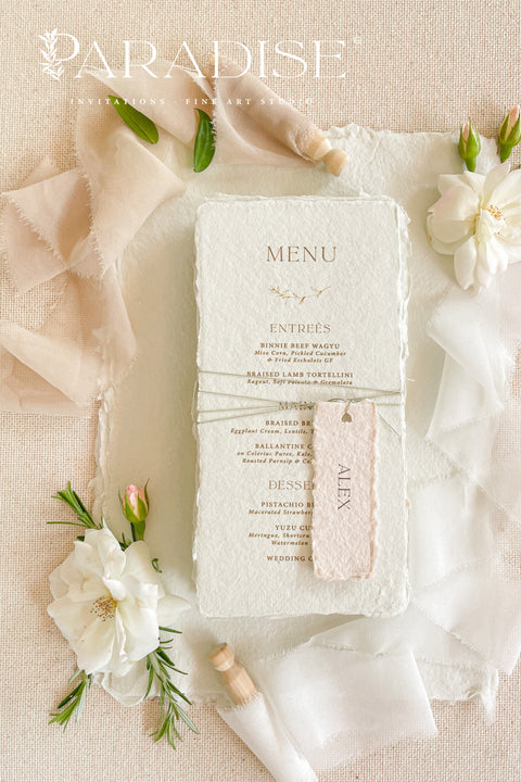 Add timeless charm and fine art elegance to your table styling with our handmade paper wedding menus, beautifully crafted from 100% cotton rag paper with naturally torn deckled edges. Each menu is adorned with a delicate name tag tied with fine thread, offering both practicality and sophistication as a combined menu and place card. The refined typography, minimal layout, and soft color palette bring a romantic yet modern touch, making these menus the perfect complement to luxury weddings, rehearsal dinners.
