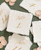 Assorted handmade paper table numbers with calligraphy script for elegant wedding tables.