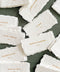 Handmade paper escort cards with deckled edges and gold guest names, luxury wedding seating cards on textured cotton paper.
