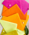 Different colored envelopes arranged in a vibrant flat lay, showcasing pink, orange, yellow, and green tones on textured linen background.