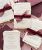 Romantic, rich, and full of timeless charm - this handmade paper wedding invitation suite is the perfect harmony of texture, elegance, and deep color. Each invitation is printed on luxurious cotton handmade paper with naturally deckled edges, exuding an organic and artisanal feel that makes every piece truly one of a kind. The suite is beautifully complemented by deep burgundy envelopes and tied with flowing silk chiffon ribbons in wine red, adding warmth, passion, and sophistication.