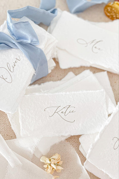 Create a soft, elegant tablescape with our handmade paper place cards, crafted from premium cotton rag paper and finished with naturally torn deckled edges. Each card showcases refined calligraphy and a romantic, fine-art aesthetic - perfect for weddings, rehearsal dinners, intimate parties, and luxury celebrations. Designed to elevate your guest seating display, these artisan-crafted cards bring texture, charm, and timeless beauty to any event.