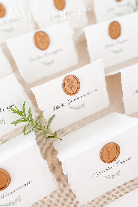 Elevate your wedding or event with our handmade paper place cards, crafted from luxurious cotton rag paper and finished with naturally torn deckled edges. Each card is adorned with a warm copper wax seal and elegant calligraphy, creating a timeless, fine-art detail that enhances any tablescape. Designed to bring organic texture, charm, and sophistication, these artisan place cards make your seating display unforgettable.