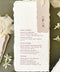 Handmade paper wedding menus with deckle edges, elegant typography, and luxury table styling.