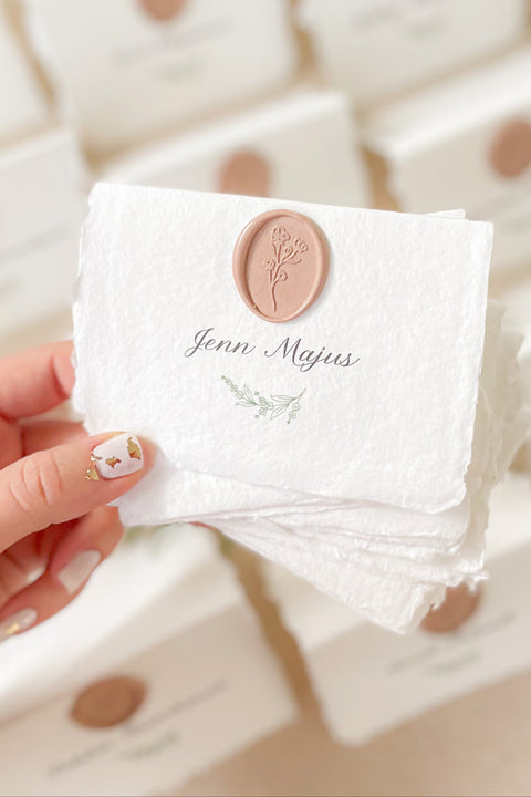 Add refined elegance to your event with our handmade paper place cards, crafted from luxurious cotton rag paper and finished with soft deckled edges. Each card features elegant calligraphy paired with a blush wax seal, creating a timeless and romantic detail for weddings, dinners, and fine-art celebrations. These artisan place cards bring texture, charm, and sophistication to any tablescape.