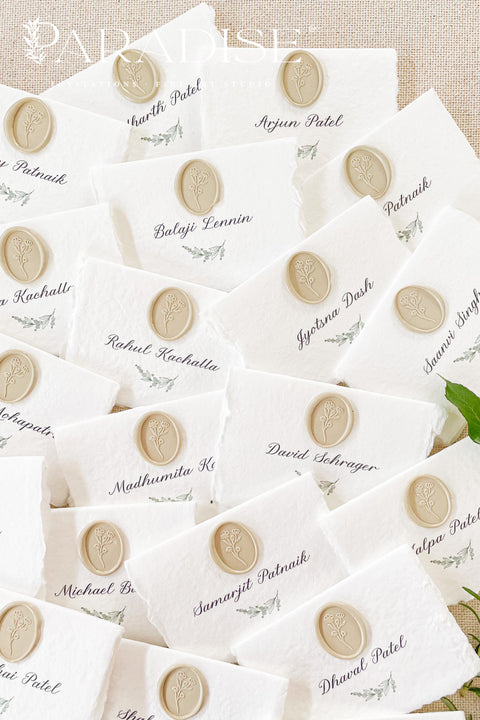 Create a refined and romantic tablescape with our handmade paper place cards, crafted from premium cotton rag paper and finished with soft deckled edges. Each card is adorned with an elegant neutral wax seal and fine calligraphy, offering a timeless accent for weddings, rehearsal dinners, and upscale celebrations. Designed to add texture, charm, and an elevated touch, these artisan-crafted place cards make your seating display truly unforgettable.
