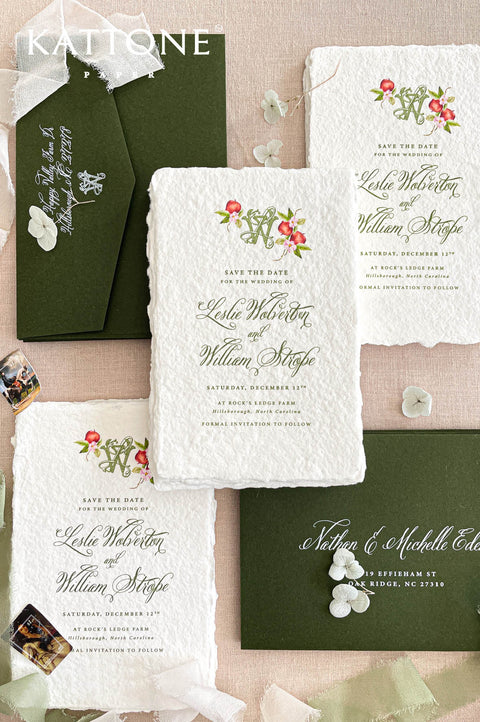 Luxury handmade paper save the date featuring deckled edge cotton paper, botanical monogram artwork, forest green envelopes, and elegant script typography.