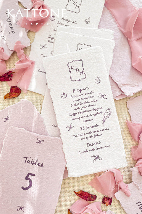 Delight your guests with our handmade paper menus with whimsical icons, featuring charming hand-drawn illustrations and organic deckled edges. Crafted from soft cotton paper, these menus bring a touch of artful playfulness and fine-art texture to your wedding tablescape. Perfect for couples who love romantic, storybook-style stationery that feels both elegant and personal.