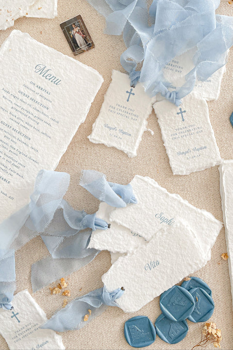 Celebrate your special occasion with our handmade paper place cards, crafted from luxurious cotton rag paper and finished with naturally torn deckled edges. Each card features soft blue lettering that pairs beautifully with baptism, christening, baby shower, and fine-art event themes. With their artisanal texture and elegant simplicity, these place cards add meaning, refinement, and timeless beauty to your table setting.