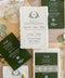 Top-down flat lay of luxury forest green wedding invitation suite featuring ivory handmade deckled-edge paper, botanical monogram crest, dark green details cards, cream lace band, sage green wax seals, beige envelopes, and custom watercolor venue envelope liners styled on a neutral linen background