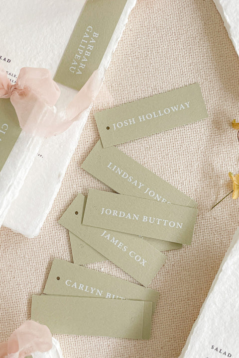 Introduce modern simplicity to your event with our place cards, crafted from premium cardstock in a soft sage color and printed with clean, contemporary typography. Their slim tag-style silhouette offers a fresh, minimalist look perfect for weddings, rehearsal dinners, corporate gatherings, or garden-inspired celebrations. These versatile cards can be displayed on napkins, tied with ribbon, or layered with menus for a refined and cohesive tablescape.