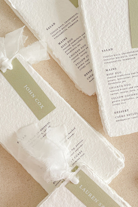 Complete your table setting with our luxury handmade paper menus, featuring delicate deckled edges, elegant typography, and personalized guest name tags tied with soft silk ribbon. Each menu is crafted on 100% cotton paper, offering a rich, tactile texture that perfectly complements fine art and romantic wedding aesthetics.