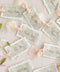 Add ethereal elegance to your event with our handmade paper place cards, crafted from delicate cotton rag paper and layered with a translucent vellum top sheet. Each card is finished with naturally torn deckled edges and soft blush ribbon, creating a dreamy fine-art look perfect for weddings, showers, and romantic celebrations. These unique layered cards bring texture, movement, and refined beauty to every tablescape.