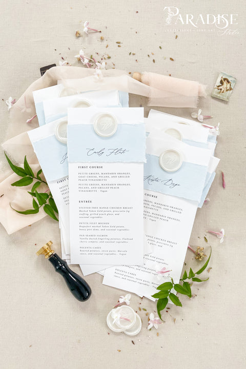 Elevate your table setting with our handmade paper wedding menus with personalized name tags, designed to merge fine-art elegance and functionality. Crafted on luxury cotton paper with a soft deckled edge, each menu features a hand-torn band and custom wax seal that doubles as a keepsake place card. The subtle dusty blue tones add a refined, romantic touch to coastal, garden, or destination weddings.