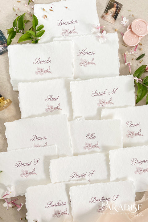 Bring soft elegance to your tablescape with our handmade paper place cards, crafted from luxurious cotton rag paper and finished with naturally torn deckled edges. Each card features romantic calligraphy paired with a delicate floral illustration, creating a fine-art aesthetic perfect for weddings, showers, intimate dinners, and elevated celebrations. These artisan-crafted pieces add organic texture, timeless beauty, and refined charm to any event setting.