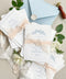 Announce your seaside celebration with these beautifully crafted handmade paper wedding invitations. Perfect for a beach wedding, this suite combines a relaxed, coastal feel with the refined elegance of artisan cotton rag paper. Each invitation features a delicate botanical design that evokes the natural beauty of the shoreline, from swaying palms to coastal foliage. The unique, deckled-edge paper adds a rustic, organic texture that is perfectly suited for a romantic oceanfront ceremony.