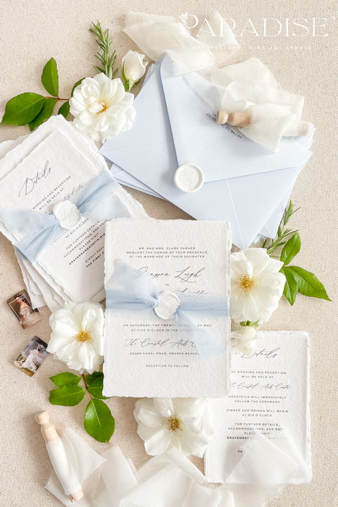 This exquisite invitation sets suite offers a blend of modern sophistication and natural beauty. Perfect for a beach wedding, these personalised invites feature a stunning, modern clean calligraphy design printed on luxurious handmade cotton paper. The tactile, rich feel of the paper beautifully complements the elegant and contemporary typography, setting a fresh and personal tone for your special day.