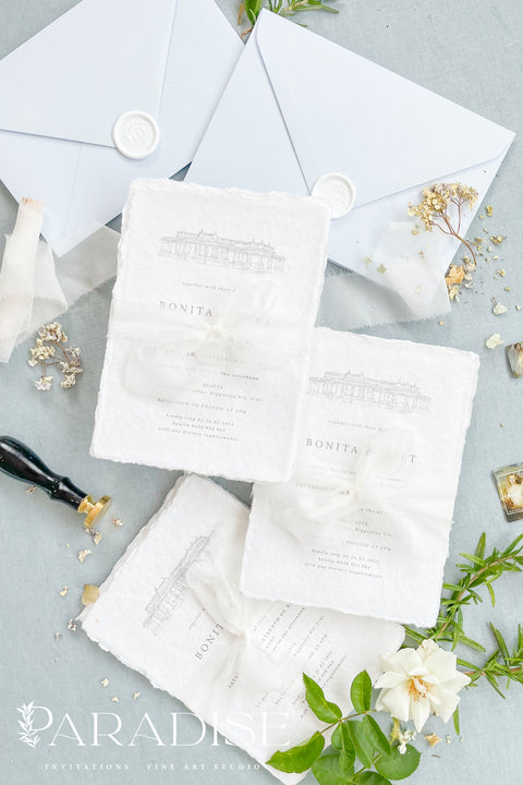 Announce your wedding with timeless sophistication through this handmade paper wedding invitation suite, featuring a hand-drawn illustration of your wedding venue - a keepsake that beautifully captures the heart of your celebration. Printed on luxury deckled-edge cotton paper. Wrapped softly with sheer ivory ribbon and paired with powder-blue envelopes sealed with wax, this suite balances elegance and sentiment, making every detail feel intentional and romantic.