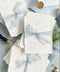 Announce your seaside celebration with a touch of vintage romance and personalization with these unique wedding invitations. Perfect for a beach wedding, this suite is printed on luxurious handmade paper, giving it a soft, textured, and truly premium feel. A bespoke custom vintage letter monogram adds an elegant and personalized touch, while the light sky theme evokes the serene and beautiful atmosphere of the coast.